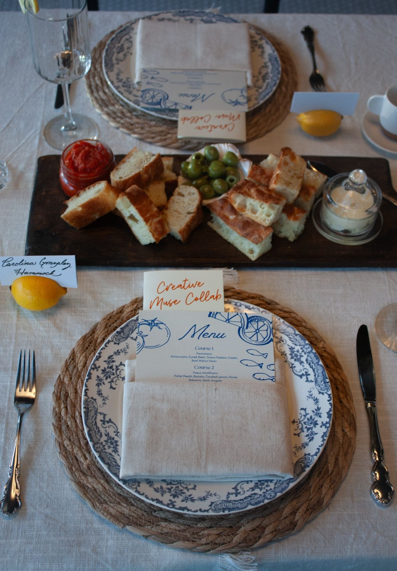 The paninoteca board of focaccia, olives and spreads beside the illustrated menu