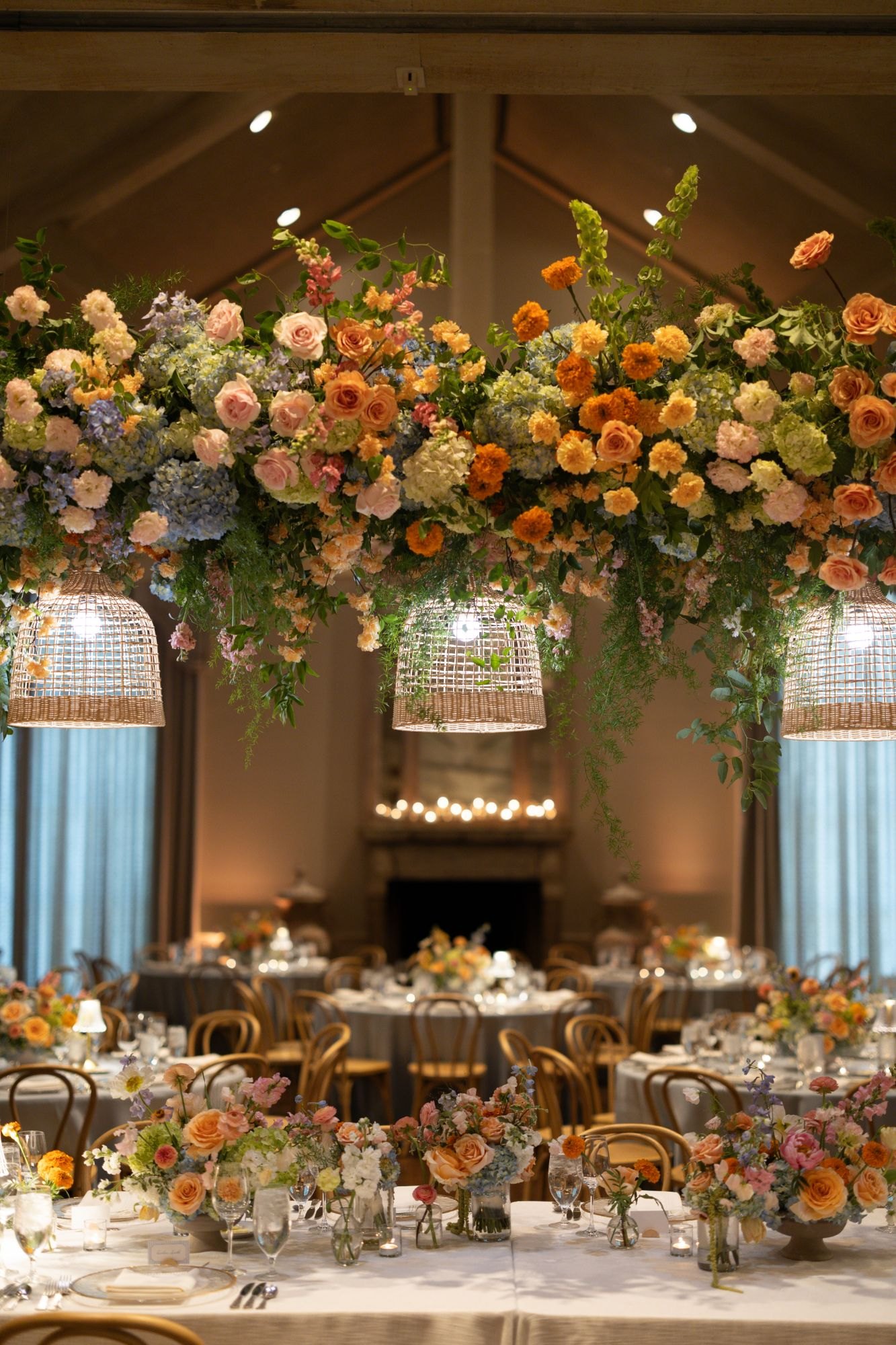 Floral chandeliers in peach, blue and marigold over the Southern Hills Country Club ballroom