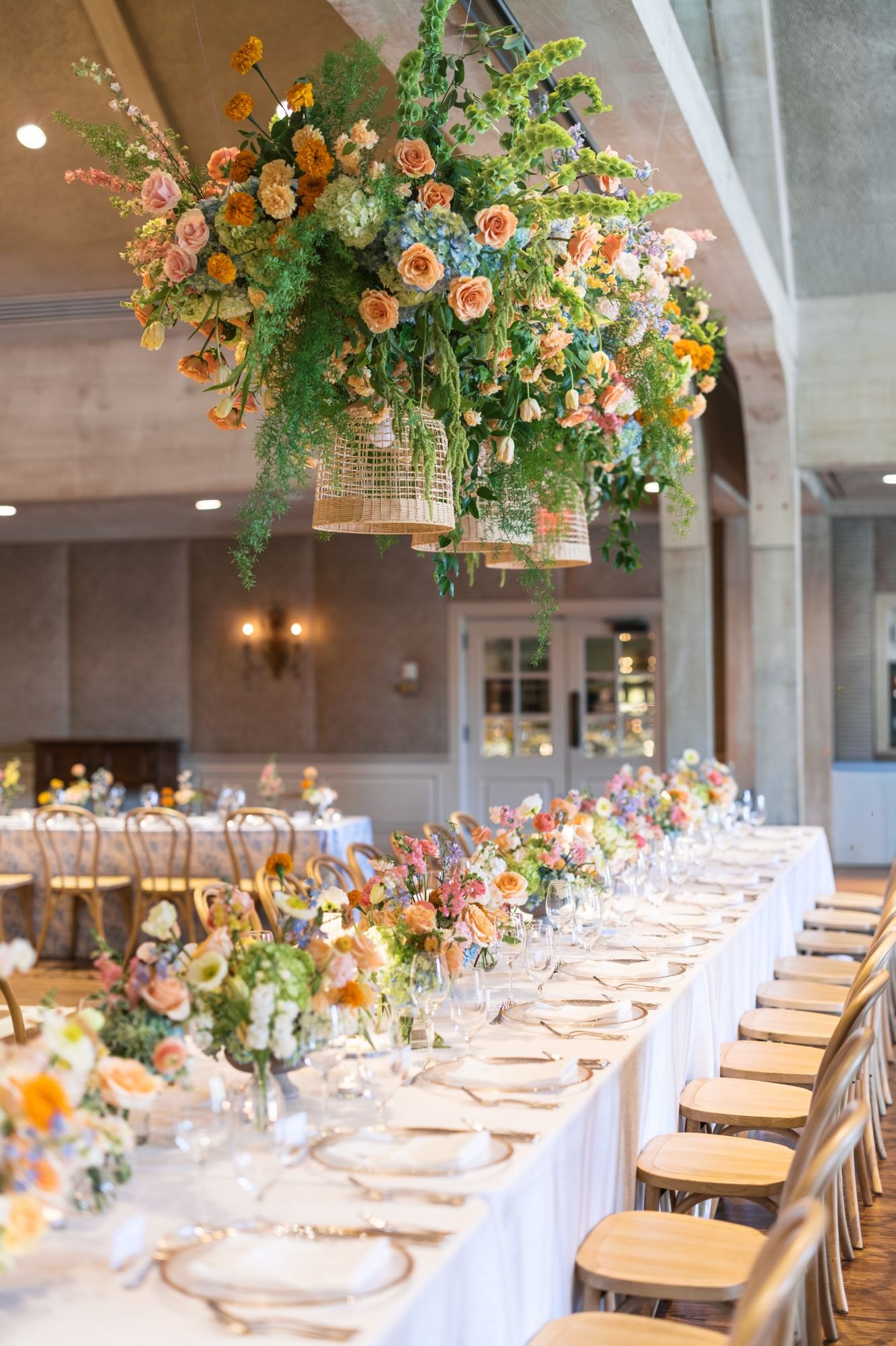 A suspended floral installation over the long head table