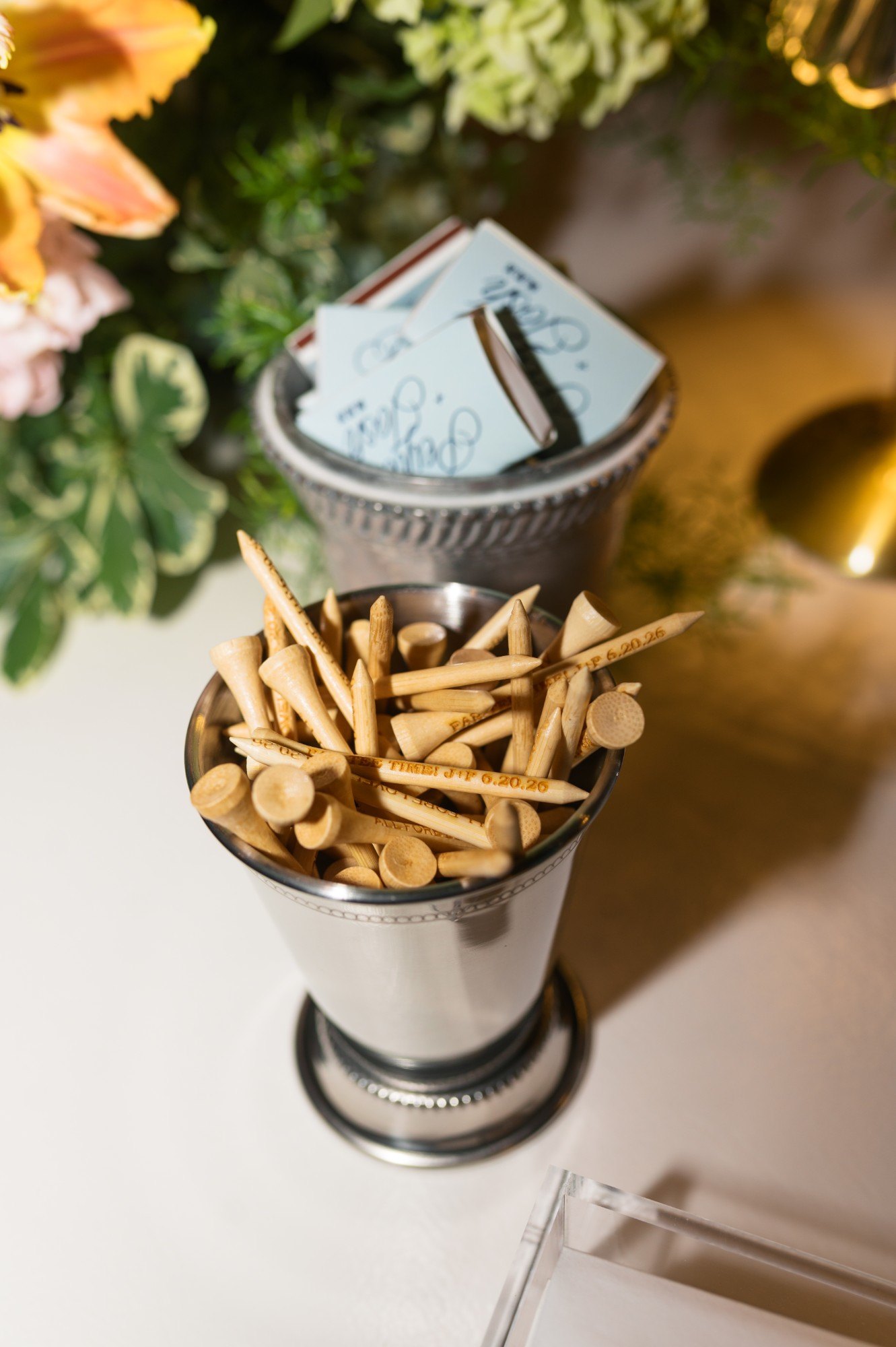 Custom engraved golf tees and calligraphed matchbooks as guest favors