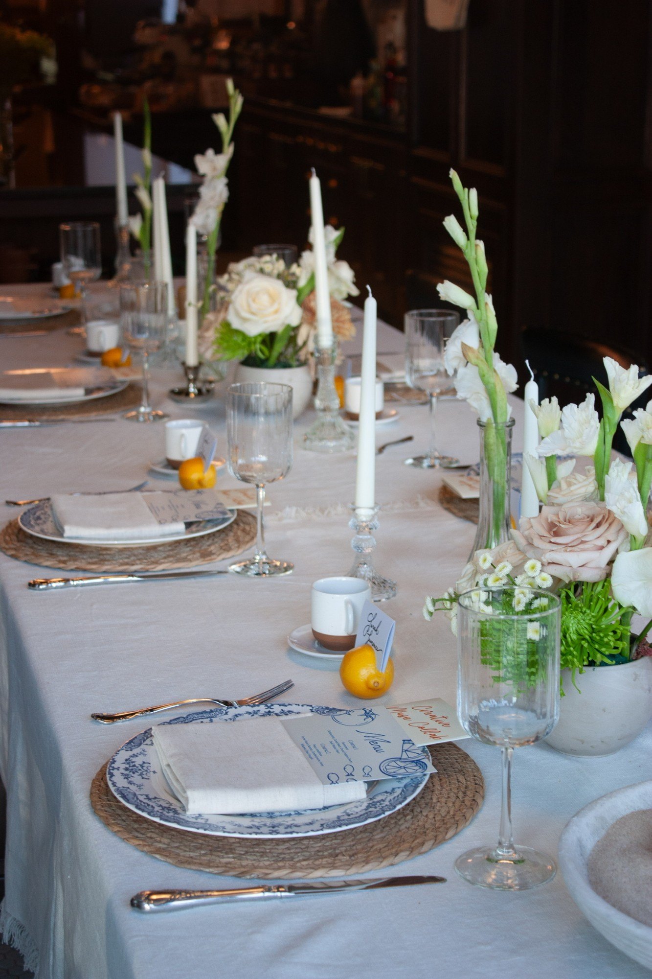 The long table set with blue and white china, gladiolus and lemons