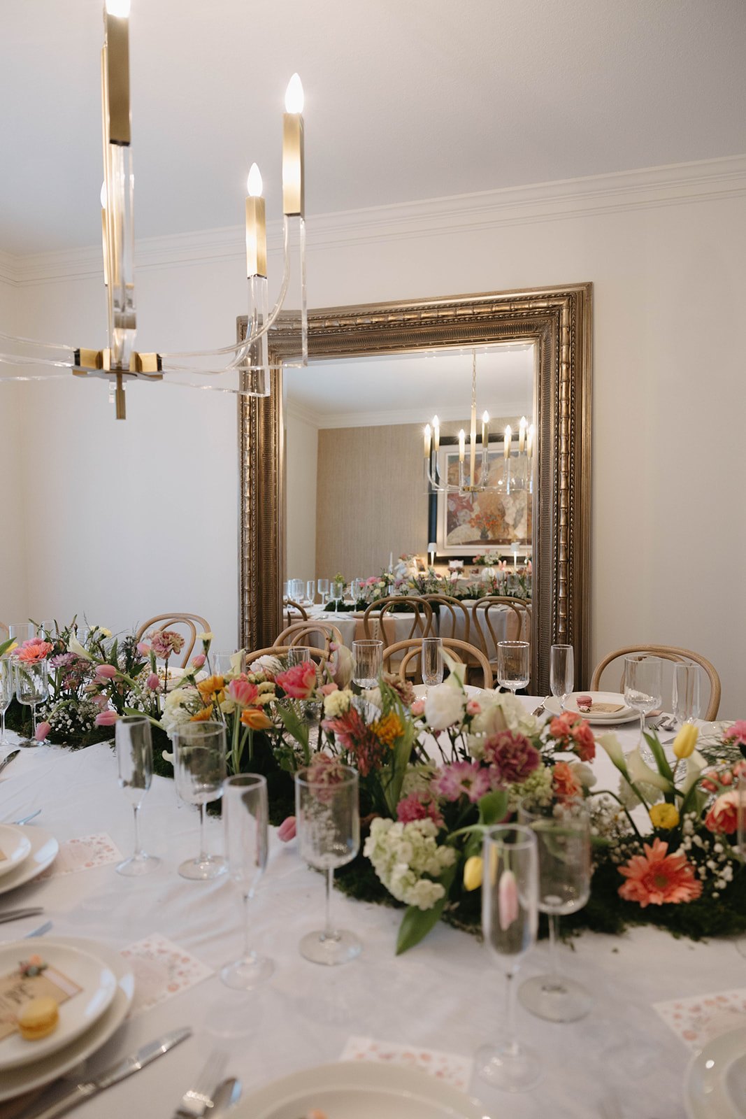 The full room in bloom, reflected in the gold mirror